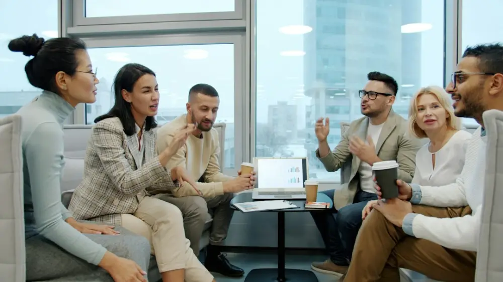Diverse group of people in a modern office meeting, illustrating humanism and dialogue